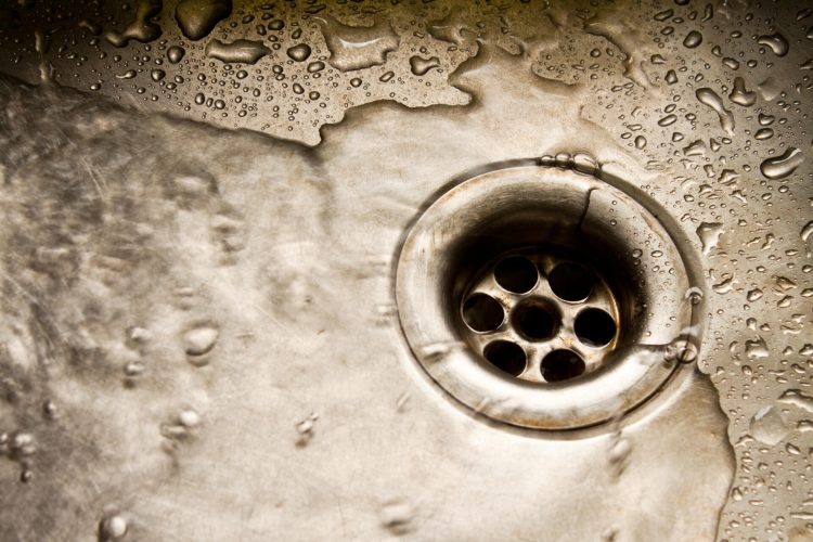 Water running down the drain, deep sinkhole